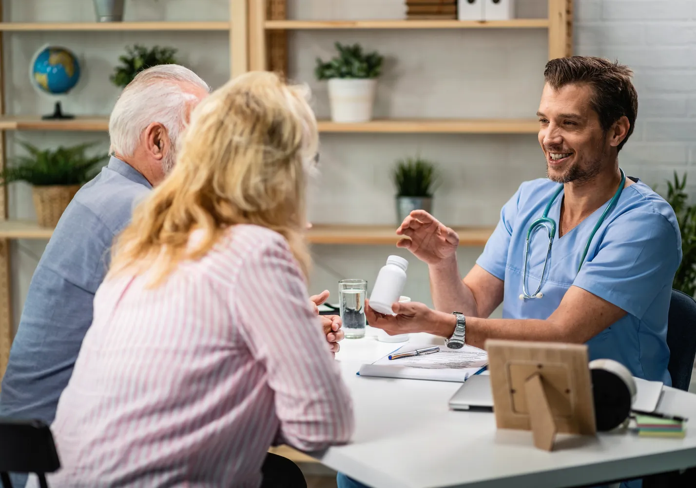 A clinician discussing a care plan with an older couple